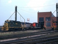 Here's a view of the old CN diesel shop facility in Fort Erie back when it was an important part of railroading in Niagara. A trio of rare visitors, D&H 7415, 7616 and 7315, give the scene some pizzazz. The first unit in Reading colours, the middle one classic D&H, and tucked in behind a unit in Lehigh Valley paint !! Of lesser interest to this photographer are a smattering of local CN units. This scene today would consist of mostly weeds, unless the Niagara Rwy museum guys, who have taken over the once abandoned shop building after CN left, have been ambitious with their landscaping.