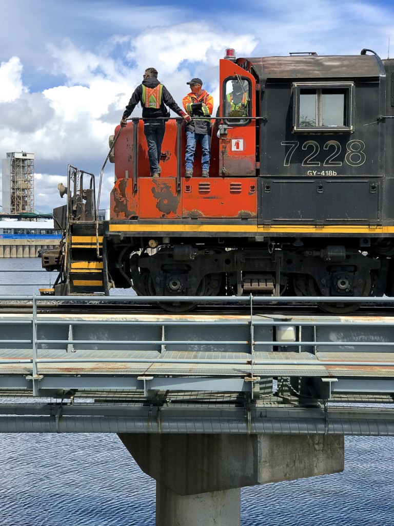 CN 7228 & CN 4773 are stopped over the Lachine Canal in Montreal, waiting for security to flag the crossings and give them the go-ahead to enter the Port of Montreal.