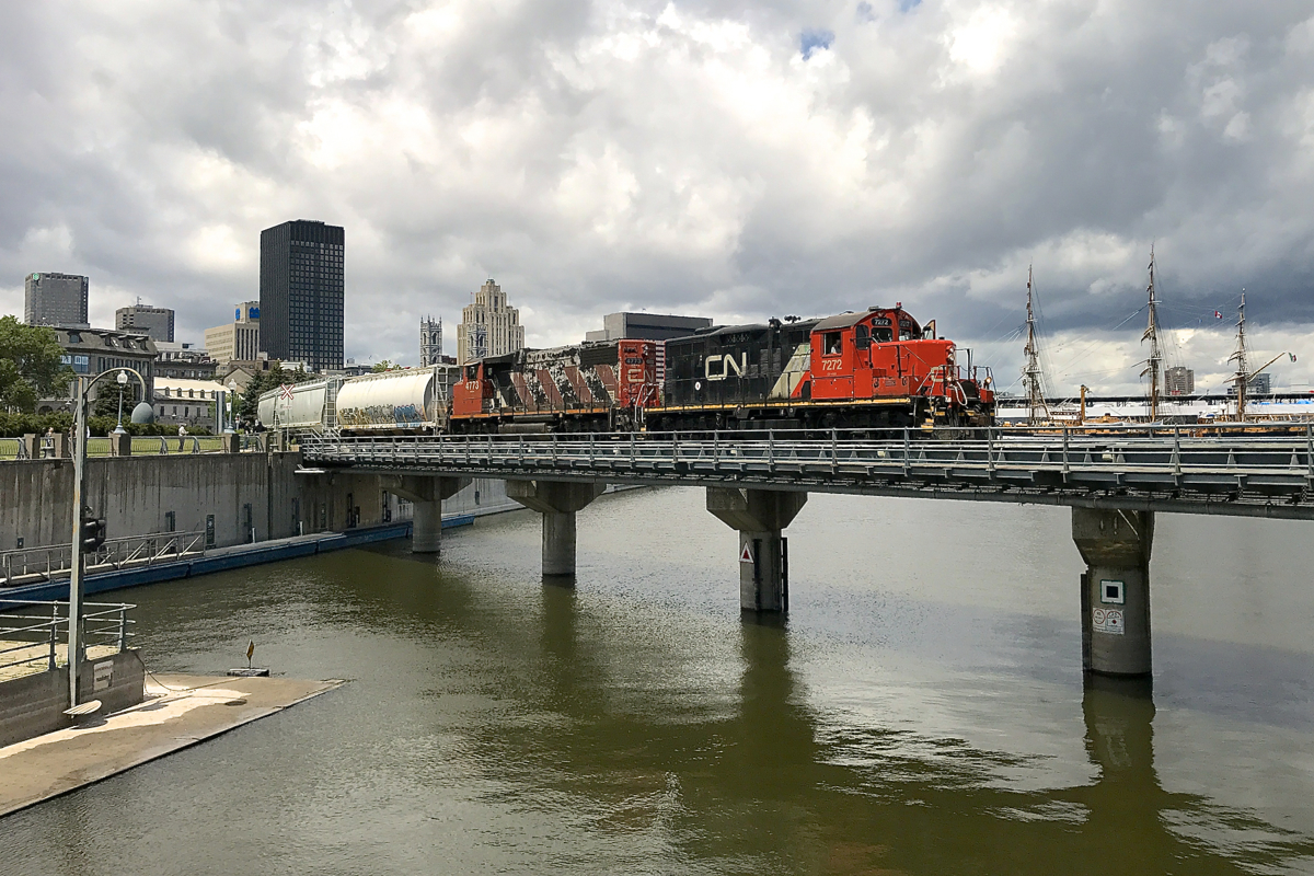 The Pointe-St Charles Switcher is passing some kind of replica sailing ship as it leaves the Port of Montreal with CN 7272 & CN 4773 for power and quite a long train.