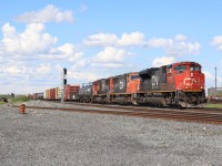 Torbram is one of those locations that is not all that scenic, but brings back a lot of memories for me from my years at Humber College. While many students went to the on campus bar "Caps" during their spare periods, I went to Torbram. Back then I shot a lot more interesting power then today, but sadly it was with a crappy point and shoot camera, but fond memories none the less. This location has changed a lot since then with the removal of Malport yard, and the end of the "Roadrailer" trains assembled there. An underpass is currently being built on Torbram Rd here and soon this railfan spot will cease to exist. The track to the left heads off into the BIT intermodal terminal. Here we have CN 399 with a trio of EMD's rolling under a mostly cloud filled sky as it heads westward.