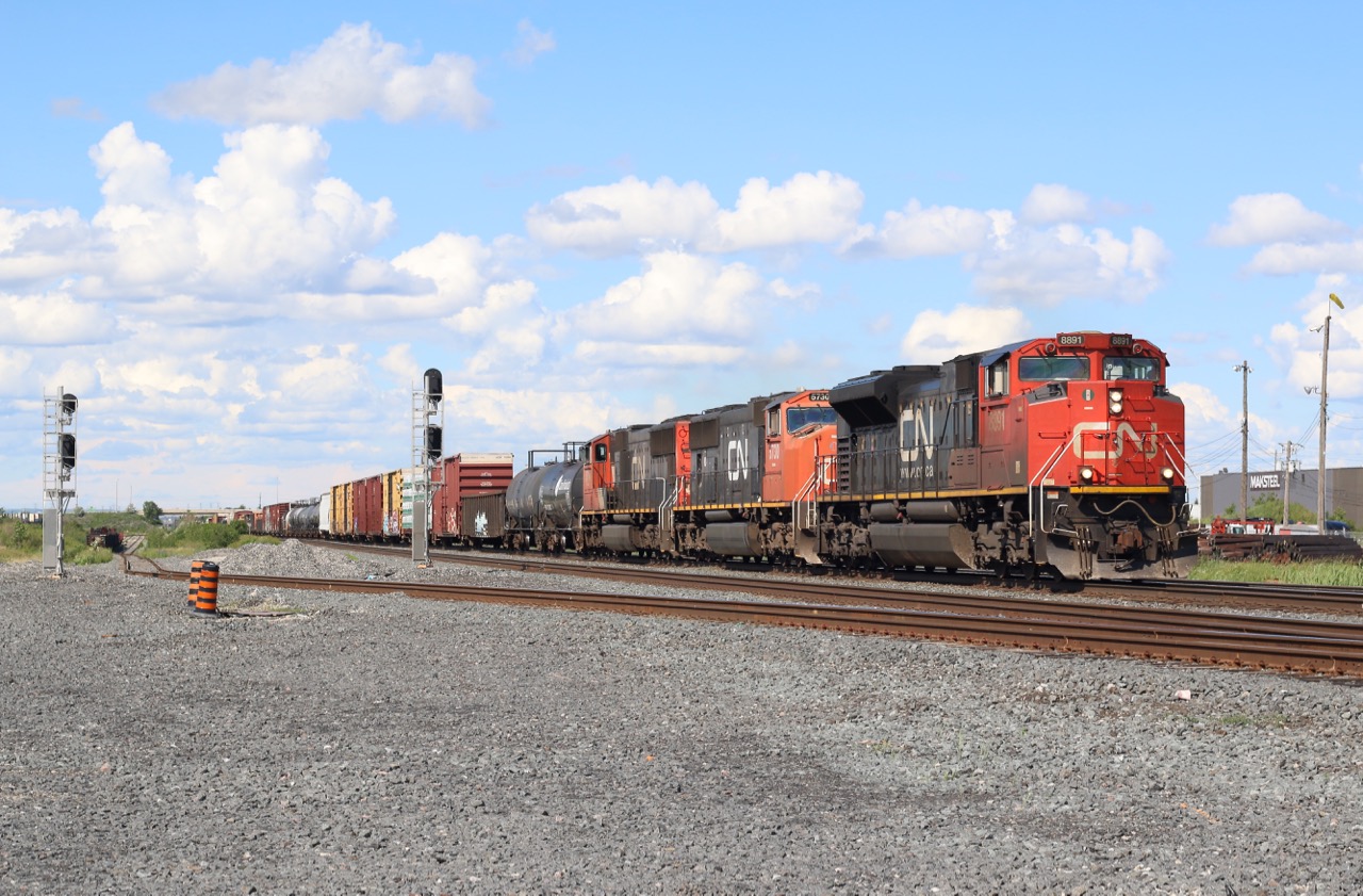 Torbram is one of those locations that is not all that scenic, but brings back a lot of memories for me from my years at Humber College. While many students went to the on campus bar "Caps" during their spare periods, I went to Torbram. Back then I shot a lot more interesting power then today, but sadly it was with a crappy point and shoot camera, but fond memories none the less. This location has changed a lot since then with the removal of Malport yard, and the end of the "Roadrailer" trains assembled there. An underpass is currently being built on Torbram Rd here and soon this railfan spot will cease to exist. The track to the left heads off into the BIT intermodal terminal. Here we have CN 399 with a trio of EMD's rolling under a mostly cloud filled sky as it heads westward.
