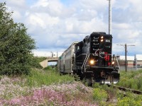 At least all of this rain has been good for all the trackside flowers, although some areas are quickly becoming overgrown. Here we see the twice a week southbound OBRY train passing the flowers at an abandoned industrial spur just south of highway 401 in Streetsville's north end, during a break in the clouds.