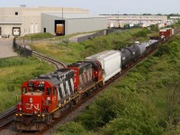 With all the new motive power around today sporting CN's current paint scheme, it sure is nice to catch a couple of old standard cab workhorses in old paint even if they are in dire need of a repaint. The GP38s have only had a few modifications over the years such as the addition of ditch lights, relocated horn and new electronic bells. The 4717 is a new unit for me. Here we see local 551 working the industries on the north track after working the glass lead. The last car, a centre beam loaded with lumber is destined for Tamarack Lumber in Burlington to be dropped on the return trip to Aldershot. 