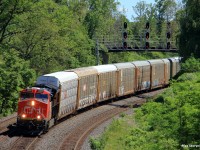 A solo Tier 4 is on point of today's autorack train X371, as they round the curve at CN Snake on the approach to Bayview Jct.