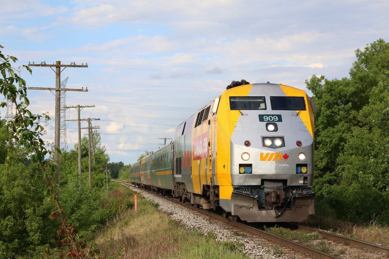 Canada 150 decorated VIA 909 passes the unused line side poles east of Acton as its Sarnia bound train races westward. It's a spot I don't photographer often as it's a bit tight, but the late day light this day helped to make the shot.