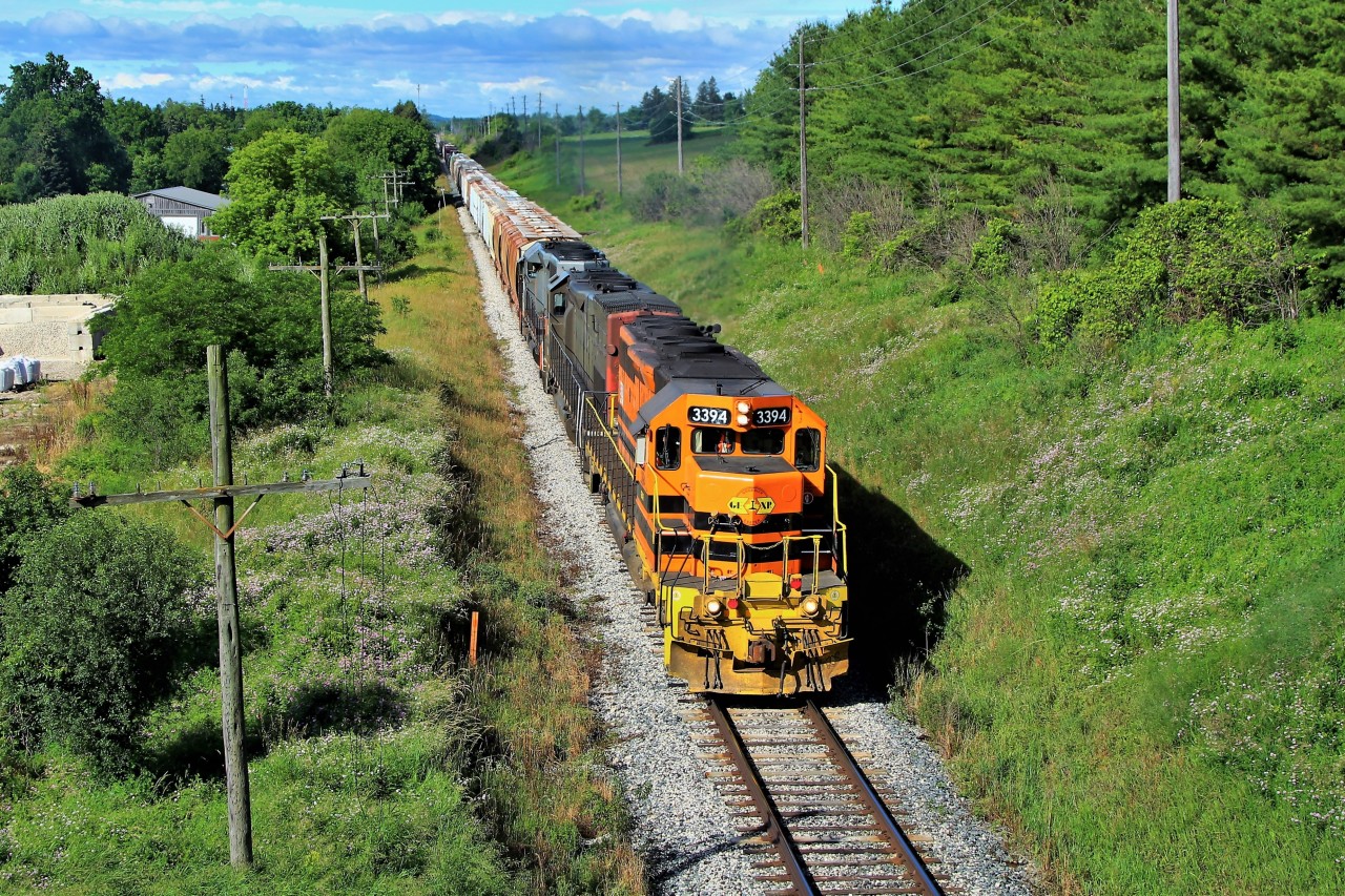 GEXR 3394 leads GEXR 3054 and QGRY 6908 out of Guelph and under the Jones Baseline Overpass.