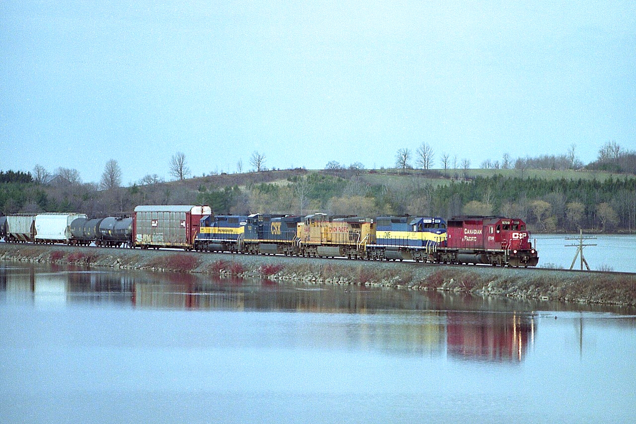 Still another example of how interesting lashups run on cruddy overcast days. I'm up in the Mountsberg Conservation grounds hoping for some clearing in the sky, but, alas, no luck. The distortion from using a telephone didn't help things either. But it is a great catch, especially compared to what we are seeing these days. Crossing the causeway eastbound are: CP 5790, DM&E 6367, UP 6440, CSXT 7923 and ICE 6446. Note that 6446 is now in the fleet of locos on the RCP&E as of 2014, and the DM&E 6367 was sold to LTEX (Larry's Truck & Electric) in 2016.