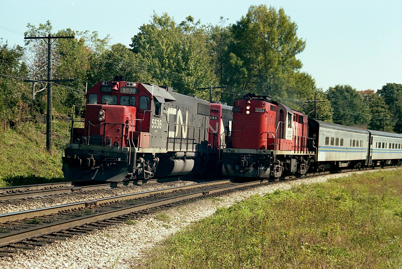 Westbound CN 5536, 5568 and 9486 just before the Broadway crossing and close to Paris Jct as it allows VIA/CN Tempo train 3152 to pass. I used to enjoy seeing the old Geeps.