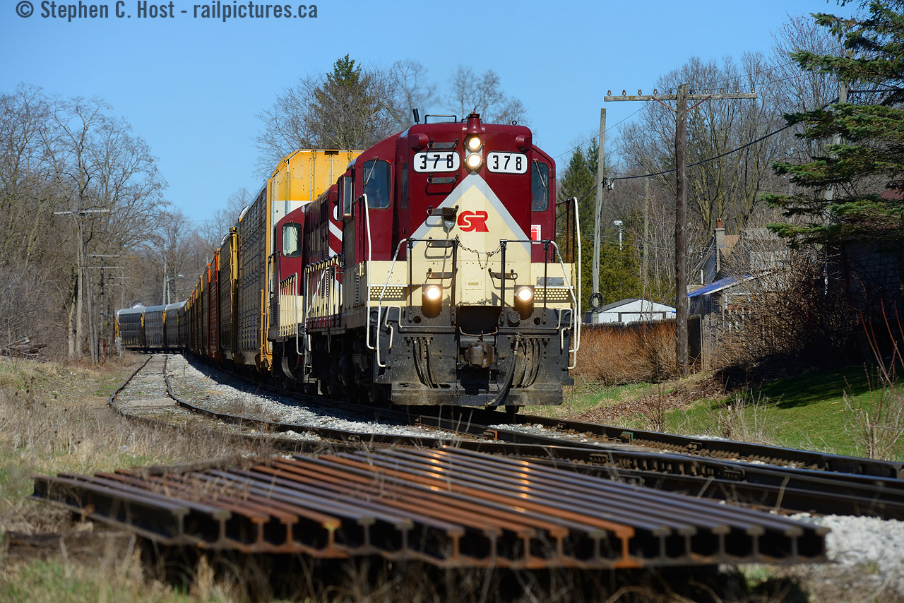 The oldest active engines on the Ontario Southland Railway roster - again, can you go wrong with a visit to the O.S.R at Salford? No, you can't. Built in 1951, and 1952, respectively, this matching pair of GP7's is seen hauling a train of autoracks from Woodstock in April passing a pile of rails used by the MOW team. These high nose geeps look smart in OSR paint, don't they.