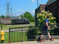 While Trillium's 1859 may be a black dip locomotive and rather lifeless in terms of it's paint scheme, it sure beats the leaser invasion that's coming around to most Shortlines as they replace older motive power. I'm dismayed to see more and more of them invading just about every shortline out there if you consider the numerous roads in the US. Many more are coming too.. so imagine my relief when I didn't see GMTX 333 and instead this old girl working in St. Catharines. I'm glad that the MLW's on Trillium are here to stay and the nasty rumours I heard late last year did not come to pass - railfan rumours can be vicious and I really only believe them when it actually happens. For the record, dropping by the shops over the weekend, Trillium has 1859, 108 and GMTX 333 in active service. Trillium 3582, which was seen in rotation in 2016 is now with the deadline with boarded up side windows. Curious, what happened to the ACR passenger cars that were stored on the line?<br><br>
After finding this old girl I followed it and their crew to Merriton capturing standard photographs all along the way, but then this scene caught my eye, and I set up for a quick photo and this feller walking by actually took notice of the train. I'd like to think it's mostly a Railfan and young kid type thing, but there seems to be more train people out there than we give credit for.


