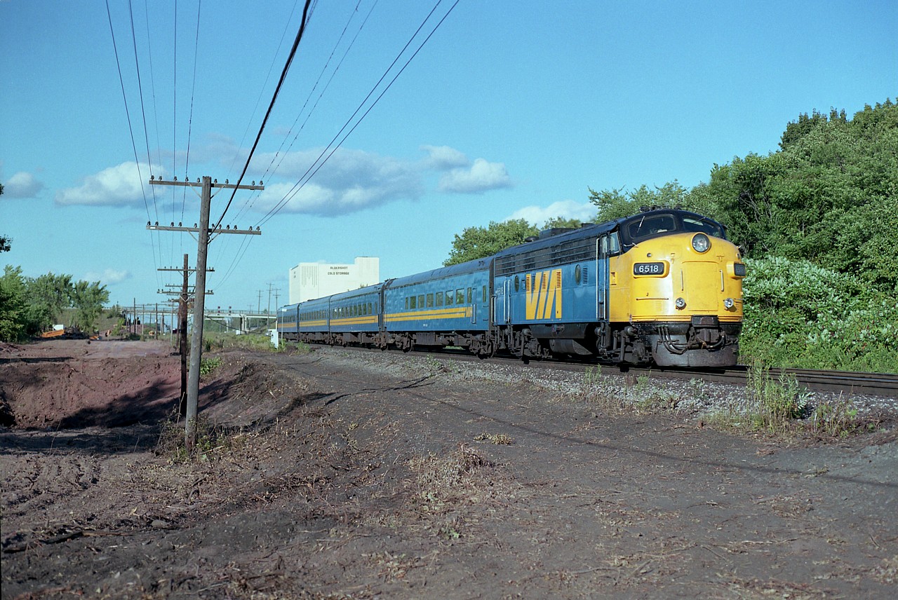 So this takes us back to summer of 1989, and I am across the tracks and a little bit west of Howard Rd., which was once a reasonable place to meet and watch trains. That is, until the third track went in......... In this view, VIA 6518, I think #77, as it is late day and this train is too dinky to be #75, speeds by in perfect sunlight. The activity on the left is the beginnings of what was to be the new yard leads for the yard expansion and future Aldershot GO facilities. Before all this change came about, it was like a country setting thru here.