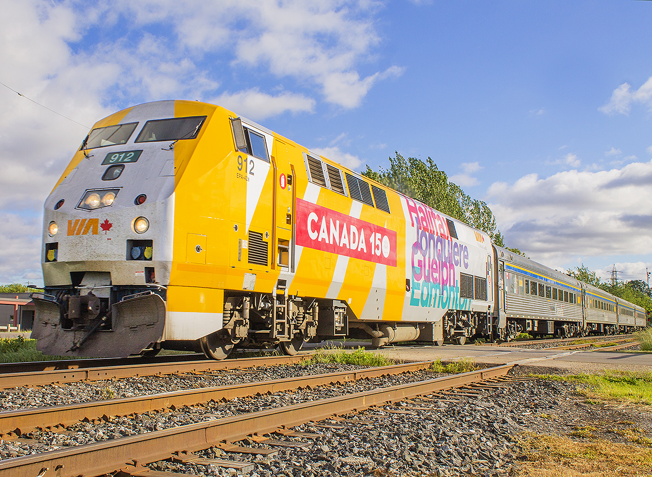 "On a warm sunny evening, on a train bound for nowhere..."  At least it feels that way sometimes here in the flat farming municipality that is Chatham-Kent, especially viewing it from through the windows of the train as it rolls through the fields of soybeans, corn, wheat, etc. Here, 78 is led by VIA 912 as it is just departing the city limits of Chatham.