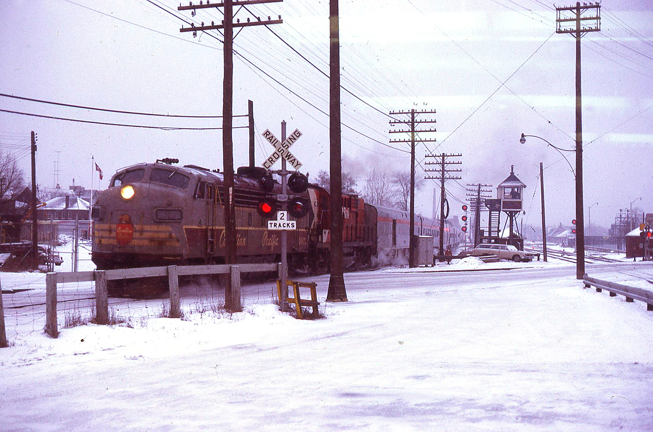 Feb 21/73 I caught train No. 11 with 4073-8574 on a dull cold afternoon leaving West Toronto. Even thought it's a cluttered image, it still provides an overview of what The Junction looked like at that time. CN's Weston Sub is on the far right, with the CP North Toronto Sub crossing east/west in the far background. And even further away is the still-standing CPR West Toronto " heritage " station. Either I took this through an open window from inside the CN waiting room, or, I walked outside and stood beneath the roof overhang. Just another day at CN West Toronto - tickets, telegrams, trains and what-have-you. (for a later-life photo of 4073, see my photo of MUCTC 1303) at http://www.railpictures.ca/?attachment_id=29750