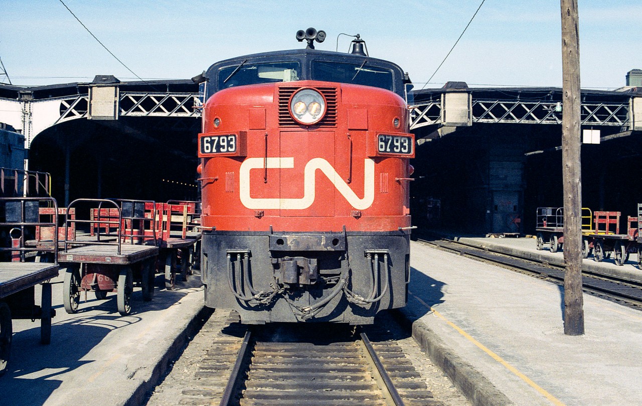 On my first trip to Toronto by myself, my dad loaned me his Nikon and let me use whatever film was in his camera bag. This was from a roll of color print film, so it is not Kodachrome quality.
CN 6793 sits outside the Toronto Union Station train shed on a warm mid-June 1972 day. (The photo date given above is approximate.) Soon she would be heading west.