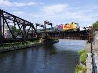 VIA 918 leads VIA 635 over the Lachine Canal. past the out of use Wellington Tower and CN swing bridge.