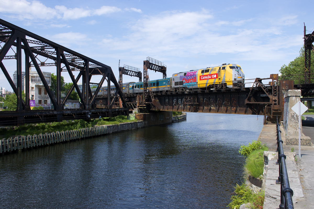 VIA 918 leads VIA 635 over the Lachine Canal. past the out of use Wellington Tower and CN swing bridge.