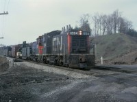 The good old days at Bayview Jct, you could drive right in, stay as long as wanted and take pictures. Image taken here on a overcast spring morning of a switcher job leaving Hamilton and heading east to somewhere. With two units back to back and sequenced numbers 1204 & 1205. Not sure of the train designation or where they were going. Had some loads of electrical equipment, most likley from Westinghouse. Also there was some type of passenger coach near the tailend, not sure if I got a picture nor what the car was.