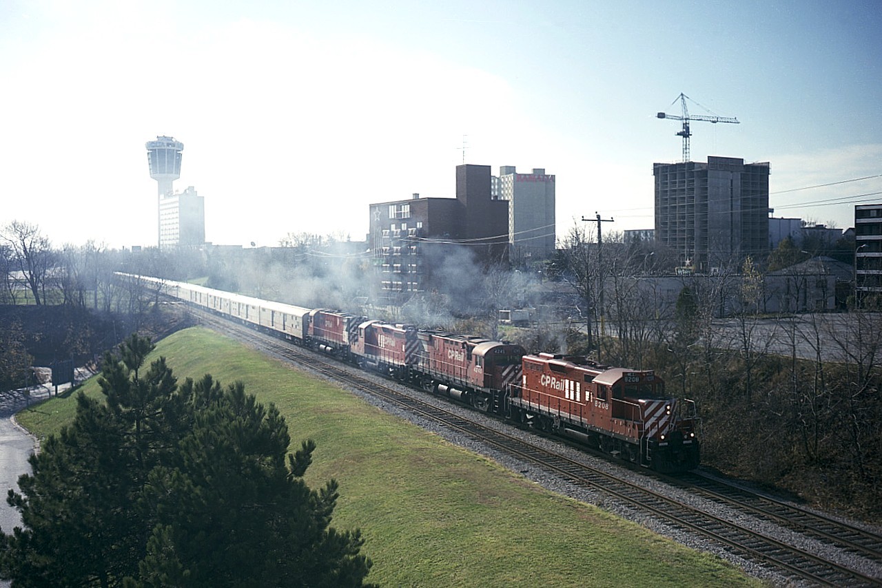Now this was a difficult shot. And it looks it. But, bugger the quality and go for the history; which is why I elected to post this. From the base of the Skylon Tower I waited, and waited. The circus train (Barnum & Bailey) was up the line out of sight, a power swap as well as the animals getting exercise and food was taking longer than I thought. And the sun angle was getting worse and worse. There was simply nowhere else to go, and I feared if I tried anything; the train would be on its' way and I would have no shot. Anyway, it was getting late by the time the show got on the road. Terrible shadow. But CP 8208, 4245, 8212 and 4222 still look pretty good as they pick up speed heading toward the core of the tourist district en route to the USA. Development was just beginning to take over. I doubt much of anything would be the same now. (The Niagara guys on this site will know what I am talking of) About 6 cars back on the train, just before the Murray St overpass; is now that big honking Casino that went up as soon as the tracks were pulled up and CP left town about 17 years ago. I've not been down there to look around and see how it has all changed. Not sure I want to.