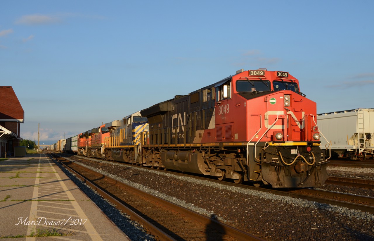 Train 505 departs Sarnia, ON., with CN 3049 and surprise trailing units CREX 1312, BNSF 5928 and BNSF 9087.
