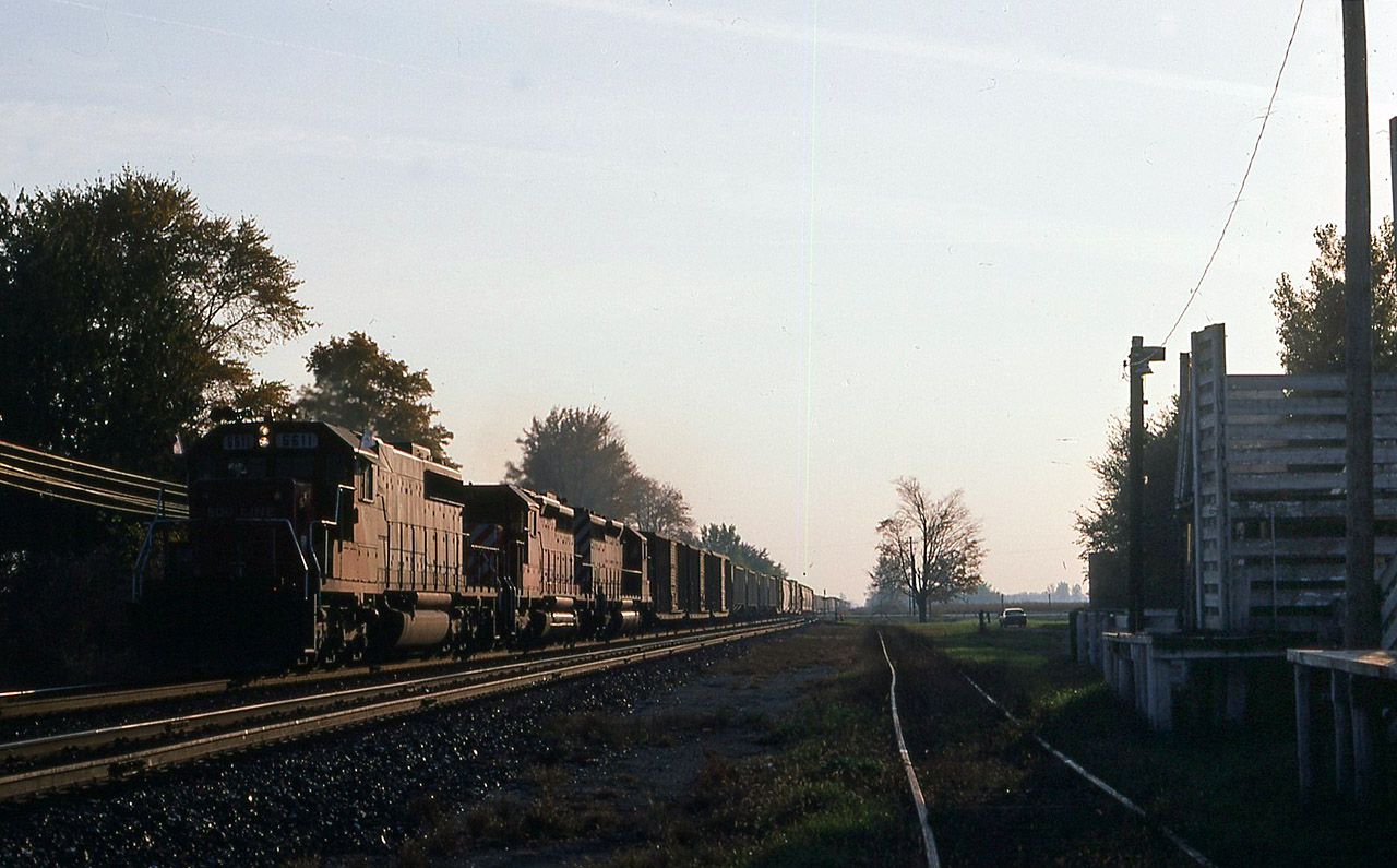 CP train 500 at Bothwell with the seldom-if-ever used cattle pens keeping an eye on Soo 6611 and CP 5546-5514 as they fly past at track speed in the early evening