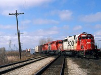 Another day at the CN/CP diamond west of Chatham, yields a 500 train with SOO 6615 leading CP 5522-5559 on it’s way from Chicago. Apr 8/87