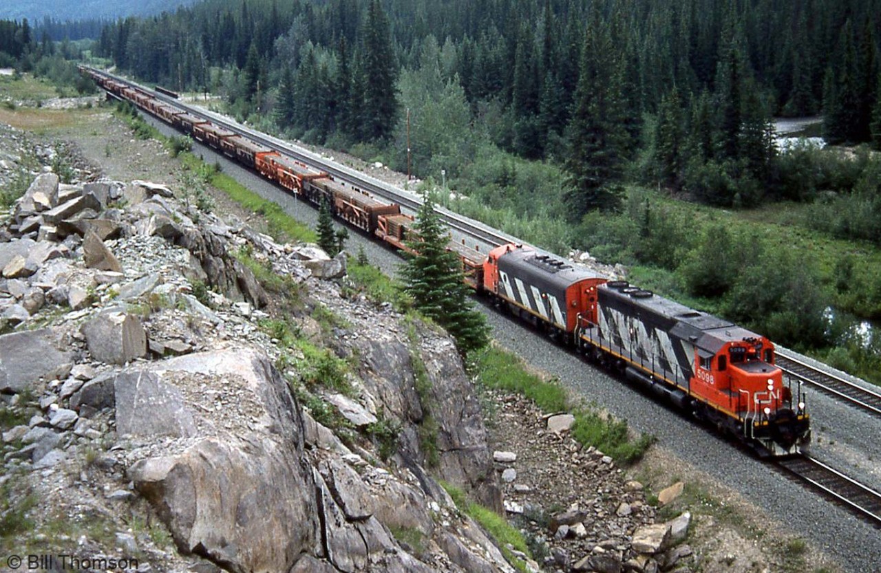 CN SD40 5098 and F7Au 9172 head this eastbound freight of rail sections at Geike, Alberta.