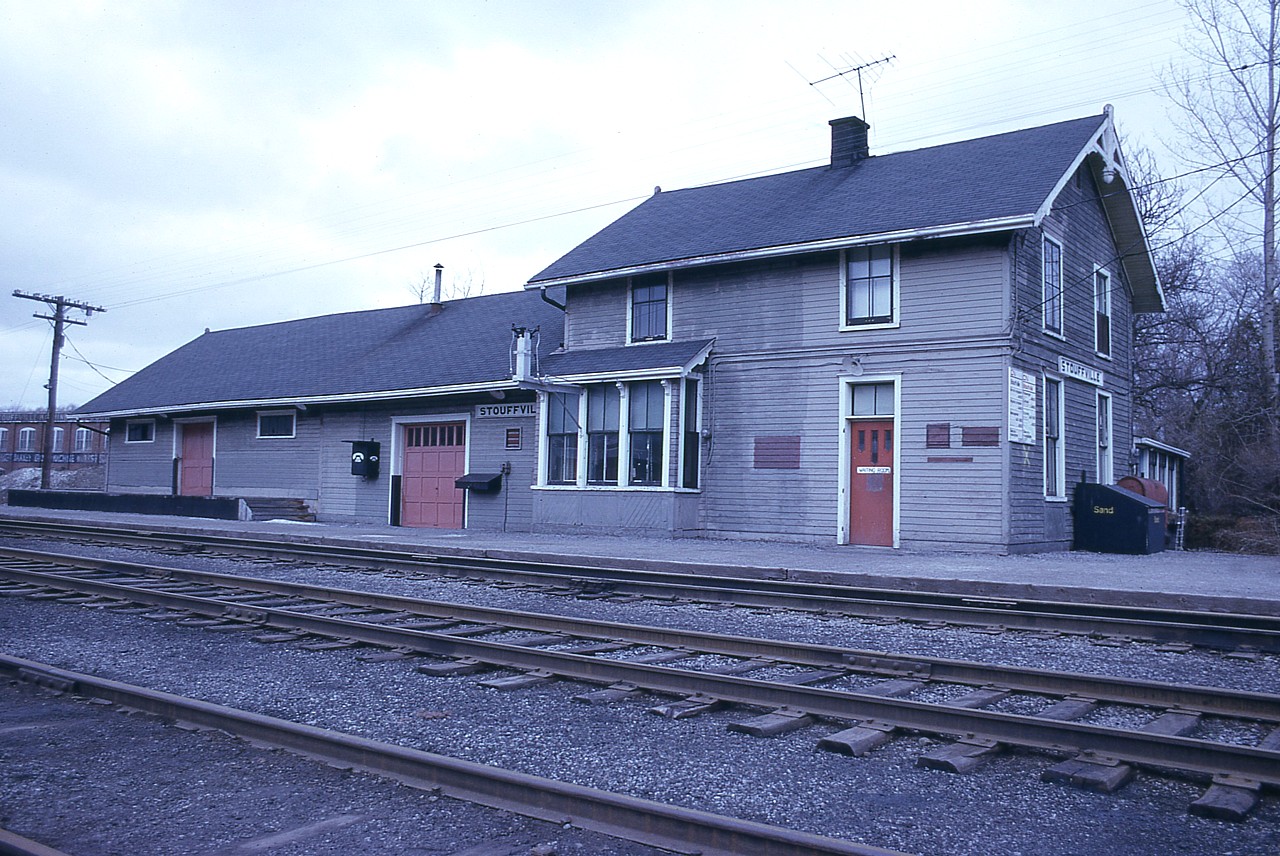 In this 1976 view of the old CN station at Stouffville, it looks like a minor facelift is taking place. Well, at least a coat of paint. This beautiful old building was built in 1886 by the Grand Trunk Rwy. It was complete with upstairs living quarters for the agent and his family. Top of the line!!!  I understand this building is now history and replaced on site by a modern station replica building. Any information appreciated.