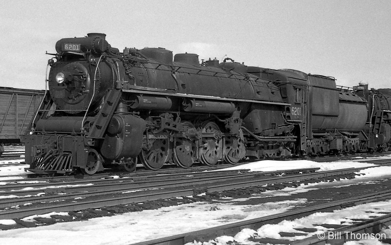 Another one of Canadian National's Northerns stored at Mimico Yard during the end of the steam era: CN 6201 (U2g-class, built in June 1942 by MLW) sits dead at Mimico with its drive rods off (sitting on the running boards), bell missing, and no coal in her tender. She would be scrapped a few months later in April 1960.