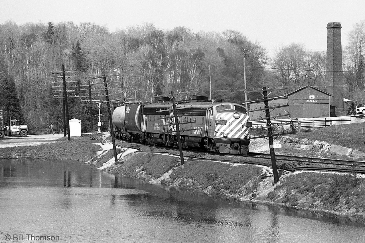 Rolling over Regional Road 1 crossing and passing the pond at Campbellville, CP FP7 4031 leads an F7B on the head end of a westbound freight heading for Guelph Junction on the Galt Sub.