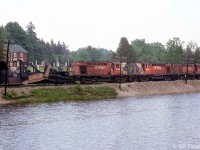 A CP Rail ballast train led by MLW RS10's 8584, 8568, & 8599 rolls past the pond at Campbellville with Jordan spreader 402895 marshalled behind the power, on CP's Galt Sub on June 7th 1979.<br><br>Typically used in winter service clearing mainlines, branchlines, yard tracks and sidings, in the warmer months Jordan spreaders were put to use on ballast trains spreading track ballast (typically done by more modern maintenance equipment today).