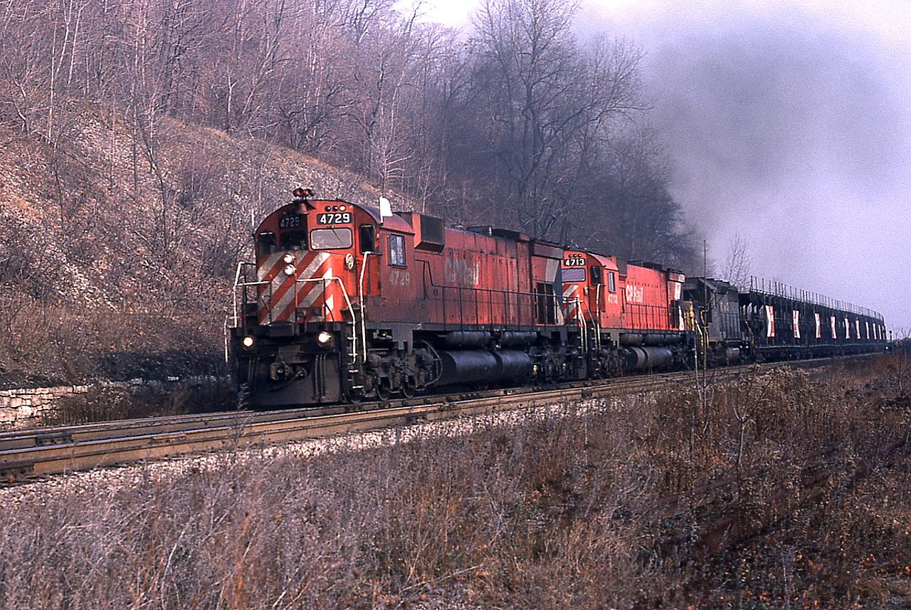 It has been just over a week since the infamous CP derailment and massive explosion and fire at Mavis Rd crossing in Mississauga. An event in which over 200,000 people were evacuated. CP continued to run detours over the CN until the CP Galt Sub was reopened to traffic. These trains were rather hard to catch, but I did get lucky with this one. Westbound CP 4729, 4713 and C&O 3537 are rolling along early morning about to round the curve on approach to Dundas Station. Those who frequented the area back then will recognize the stone retaining wall, and just above it, the track that led up to the Canada Crushed Stone operation, which by this time had been closed about 6 years.