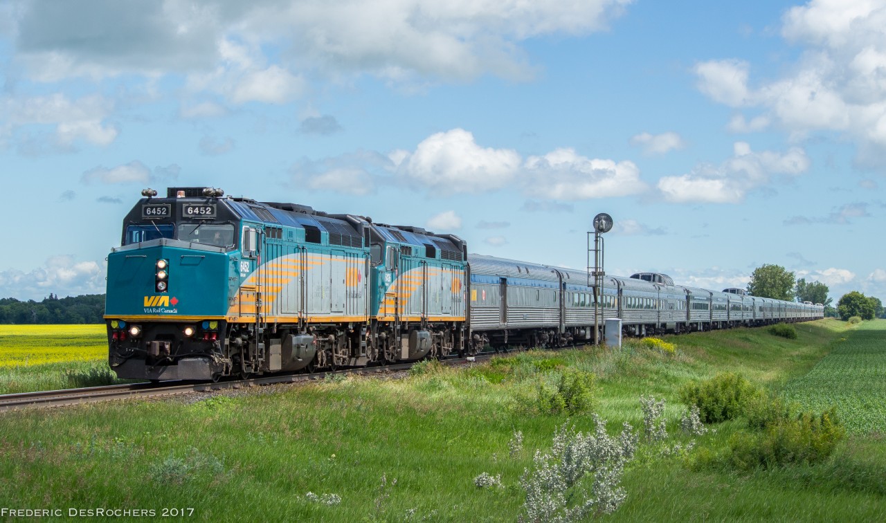 With a big wave from the crew, the Canadian makes its way through Manitoba on a sunny Canada Day.