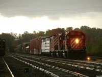 It was a rainy evening in MacTier as CP 5985 North waits for a fresh crew to Cartier in track 2 with train 221 to Winnipeg. Before they depart they'll set off those 2 centerbeams into the North leg of the wye for the local Timber Mart to come unload, a service that has now disappeared along with the wye at MacTier and the locomotives pictured here. 