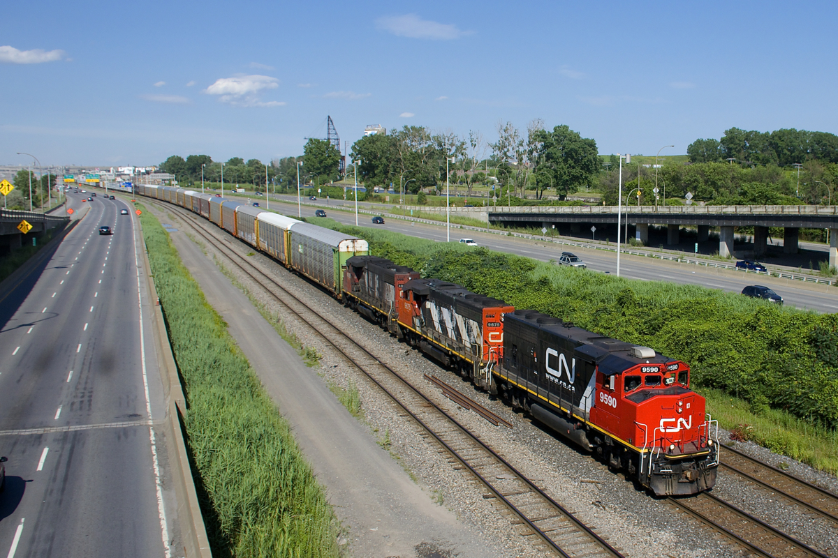 CN 401 has an old school lashup consisting of GP40-2L(W)'s CN 9590 & CN 9675 with GP38-2W CN 4806 third as it approaches Turcot West with 72 cars in tow. While the leader is quite clean (and was recently one of two units on a CN Confederation Train from Montreal to Ottawa), the two trailing units are in a quite faded zebra paint scheme.