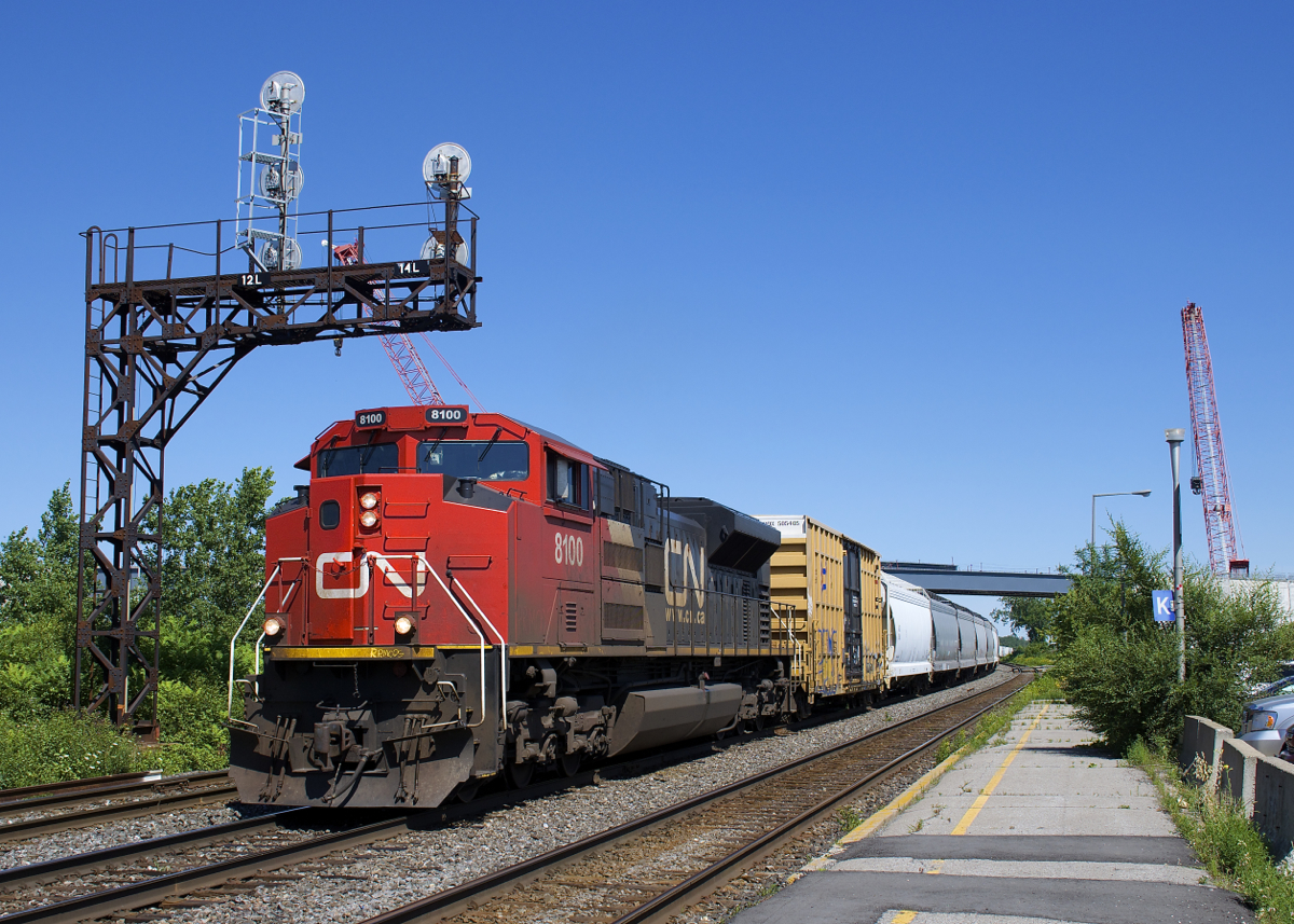 One of four. CN only has four SD70ACe's (all ex-demo's) and one of them (CN 8100) leads a 186-car CN 377 through Dorval, with CN 3076 operating mid-train. Interestingly enough one of the other four (CN 8103) led CN 368 through here just a couple of hours before.