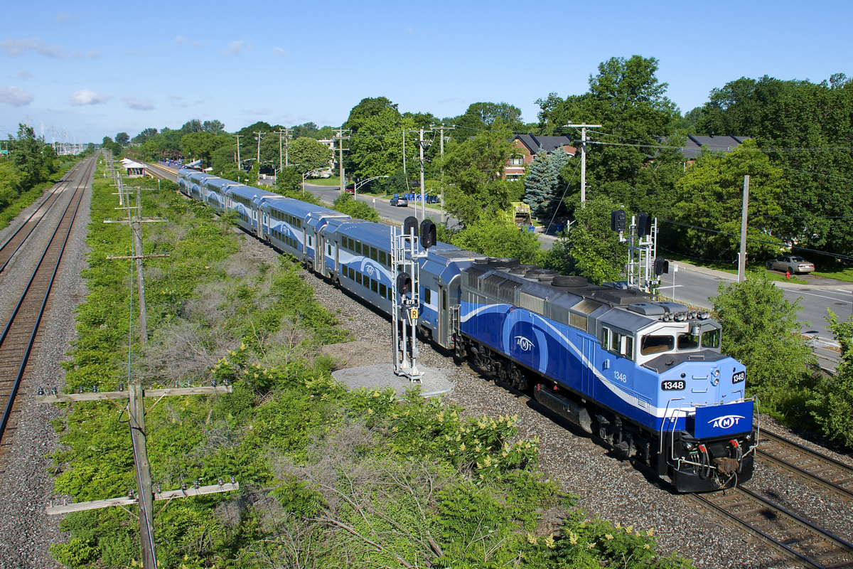 AMT 18 with ex-GO Transit F59PH AMT 1348 splits the signals in Pointe-Claire after making its stop at Cedar Park Station (visible in the distance at left).