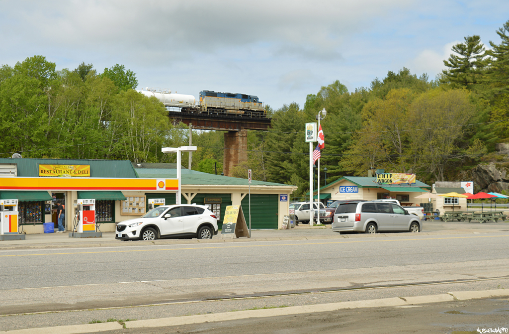 DH 7304 North crosses over downtown Pointe Au Baril spraying the weeds along the way to Sudbury.