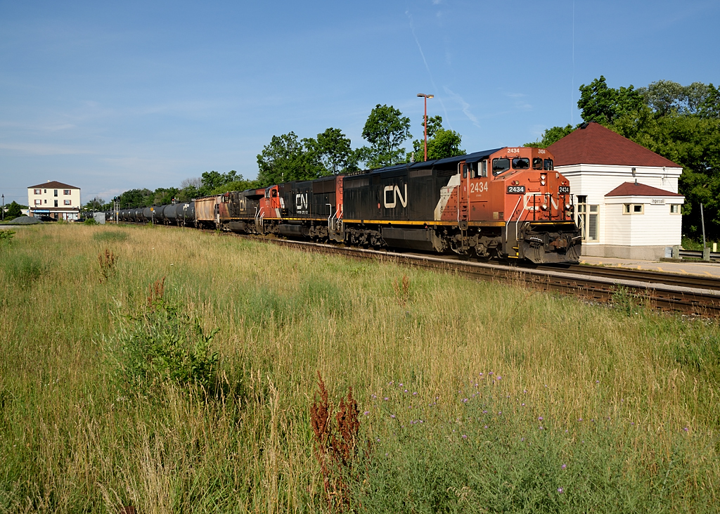 A repainted CN 2434 leads CN 435 past the Ingersoll VIA station