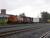 CN 324 has a pair of GP40-2L(W)'s in contrasting paint schemes (CN 9524 & CN 9515) as it heads through St-Henri on a rainy afternoon with a short train for the NECR in St. Albans, Vermont.