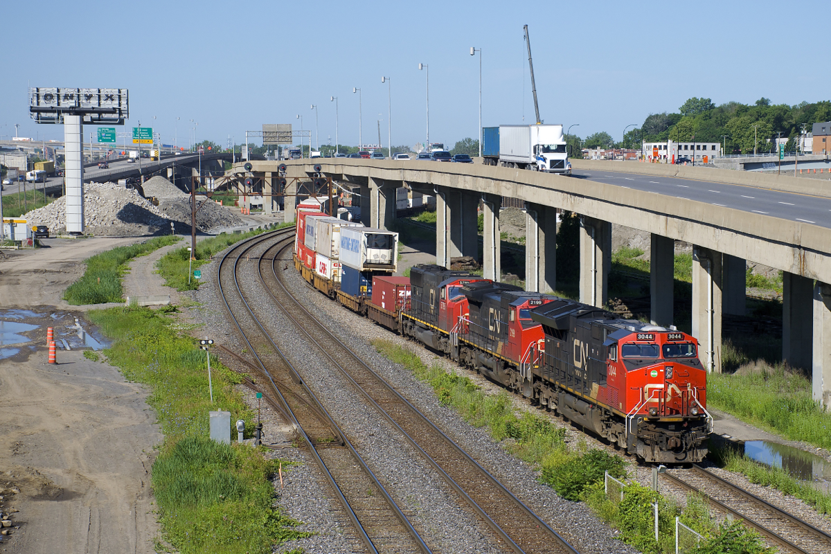 CN 120 has CN 3044, CN 2199 & CN 5795 as head end power and DPU CN 2880 as it heads east on the freight track of CN's Montreal Sub with 624 axles. Normally this train is on the north track, but CN 149 is seen lined on the south track and soon after VIA 33 would be lined on the north track.