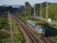 VIA 39 from Quebec City is westbound through Pointe-Claire with VIA 6439 leading a mixed consist.