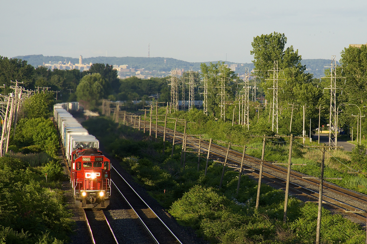 CP 133 has a pair of SD30C-ECO's (CP 5005 & CP 5048) as it heads west through Pointe-Claire. with Mount Royal in the background and CN's Kingston Sub at right.
