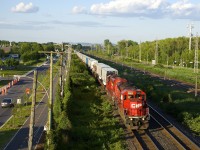 CP 133 and CP 132 (the <i>Expressway</i> piggyback train between Montreal and Toronto has been running with nearly 100% EMD power for at least six months now. SD30C-ECO's tend to predominate, with SD60's, SD40-2's, GP38-2's and GP20C-ECO's also putting in appearances on what had been a GE-powered train most of the time the past few years. Here CP 133 has a pair of SD30C-ECO's (CP 5005 & CP 5048) as it heads west through Pointe-Claire not too long after the sun reappeared, allowing me to get my first sunny shot of CP 133 this year.