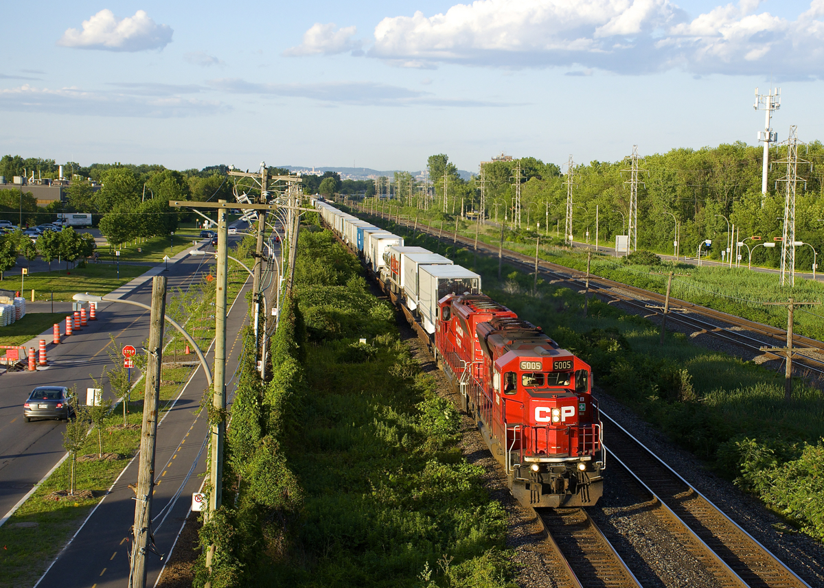 CP 133 and CP 132 (the Expressway piggyback train between Montreal and Toronto has been running with nearly 100% EMD power for at least six months now. SD30C-ECO's tend to predominate, with SD60's, SD40-2's, GP38-2's and GP20C-ECO's also putting in appearances on what had been a GE-powered train most of the time the past few years. Here CP 133 has a pair of SD30C-ECO's (CP 5005 & CP 5048) as it heads west through Pointe-Claire not too long after the sun reappeared, allowing me to get my first sunny shot of CP 133 this year.