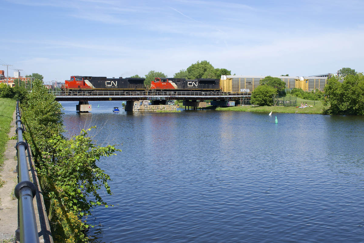 IC 2701 & CN 8918 lead CN 401 over the Lachine Canal on a hot summer afternoon.