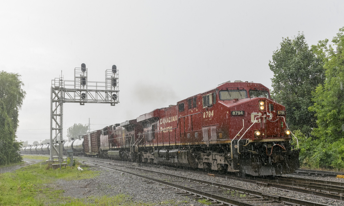 CP 650 has CP 7894 & CP 9754 for power with ethanol loads on their way to Albany, NY as it passes through Lasalle in the pouring rain.