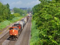 CN X321 has CN 5621 & CN 2646 for power and overflow traffic from Southwark Yard in St-Lambert as it slowly heads west through Lachine not too long after the sun came out after a quick downpour.
