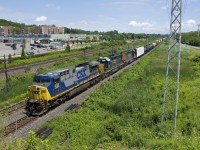 CSXT 438, CSXT 8135 & CSXT 4067 lead CN 327 through Pointe-Claire. A short version this day, with only 51 cars (27 of them lumber loads).