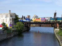 Both AMT 814 and VIA 37 have just left Central Station in Montreal as they cross the Lachine Canal. AMT 1357 is leading AMT 814, which is heading to Mont-Saint-Hilaire, while wrapped unit VIA 918 is shoving VIA 37, on its way to Fallowfield.