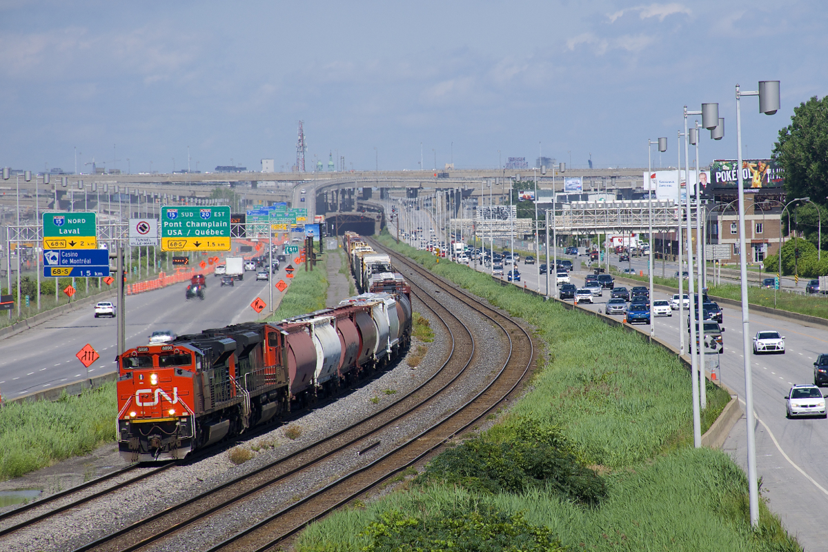 A pair of SD70M-2's (CN 8898 & CN 8006) lead CN 527 on the freight track of CN's Montreal Sub, with the soon to be replaced Turcot interchange in the background.